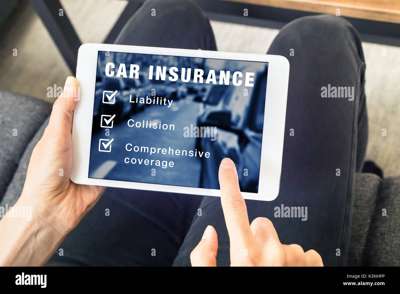 Person choosing car insurance coverage options (liability, collision, comprehensive) on website on digital tablet computer screen, vehicle and risk pr Stock Photo