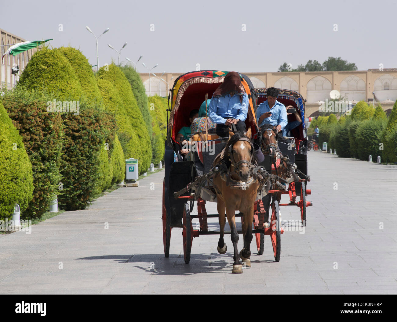 Horse and cart carrying domestic Iranian tourists around Imam Square. Isfahan, Iran Stock Photo