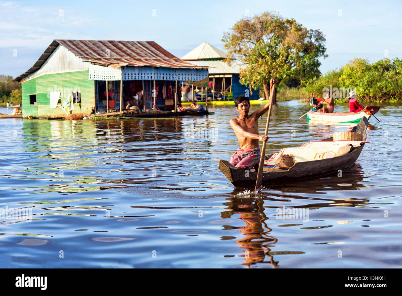 Tonle Sap lake, Cambodia - January 04, 2017: View of an unidentified man rowing in his boat. Tonle Sap refers to a freshwater lake Stock Photo