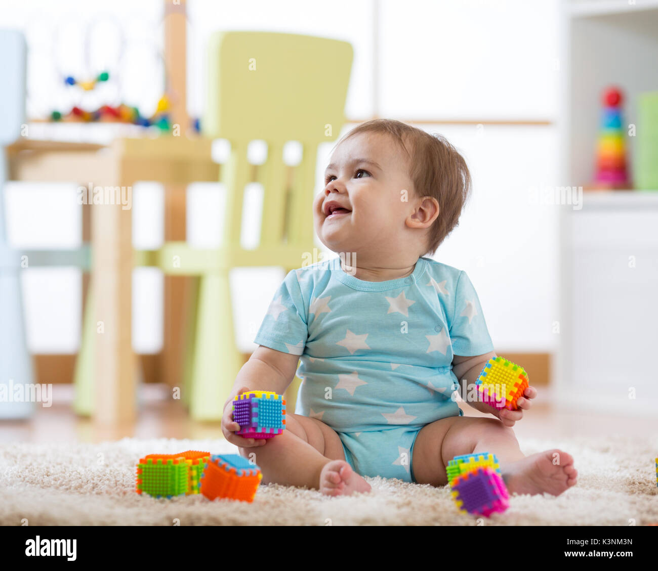 baby boy playing with toys at home nursery or kindergarten Stock Photo