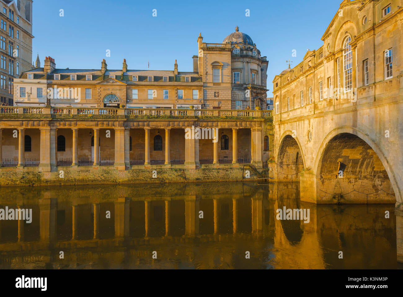 Bath historic, Pulteney Bridge and a neoclassical Georgian colonnade alongside the River Avon in the centre of the city of Bath, Somerset, England, UK Stock Photo