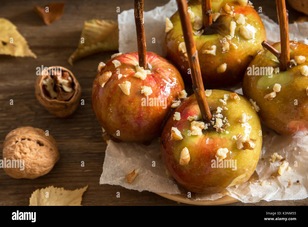 Homemade Caramel Apples on a Stick for Halloween. Organic Snack - Caramel Apples with Walnuts. Stock Photo