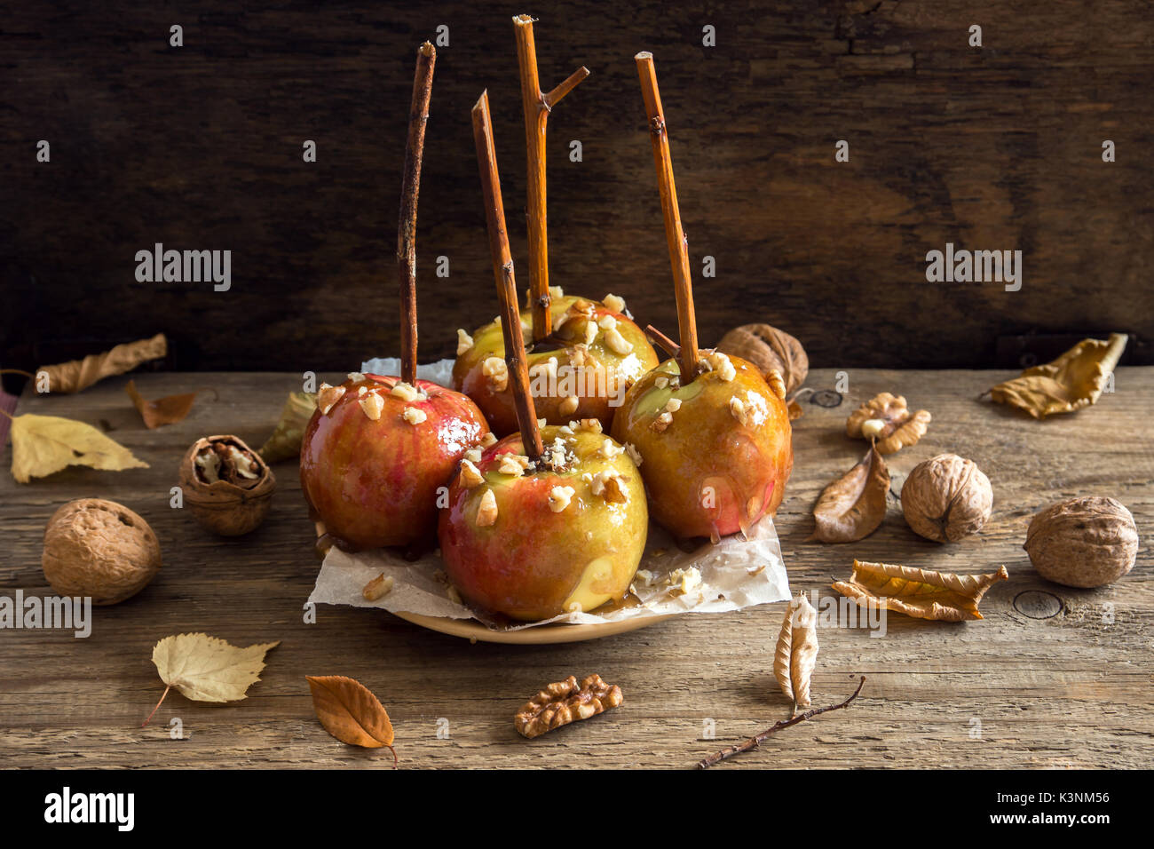 Homemade Caramel Apples on a Stick for Halloween. Organic Snack - Caramel Apples with Walnuts. Stock Photo