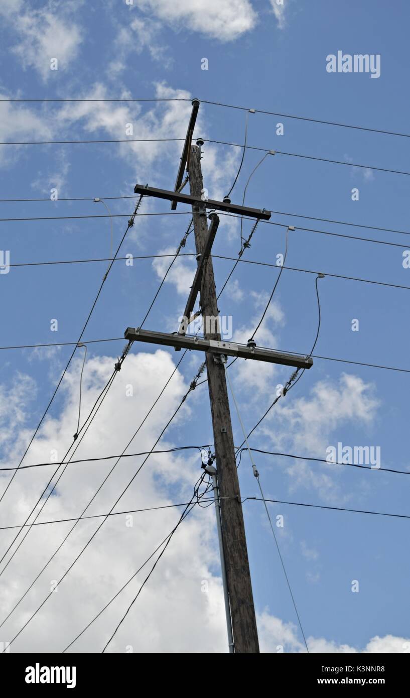 Wooden power utility pole and clear and cloudy blue sky Stock Photo Alamy