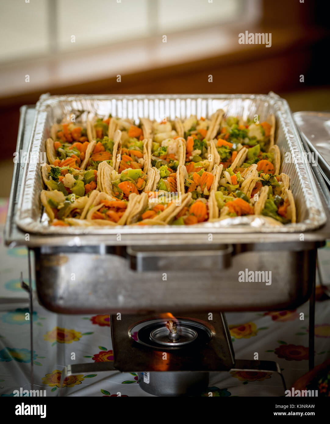 Burner flame keeps tacos warm until ready to eat Stock Photo
