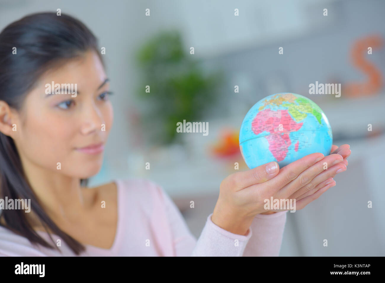 Woman holding globe on hands hi-res stock photography and images - Alamy