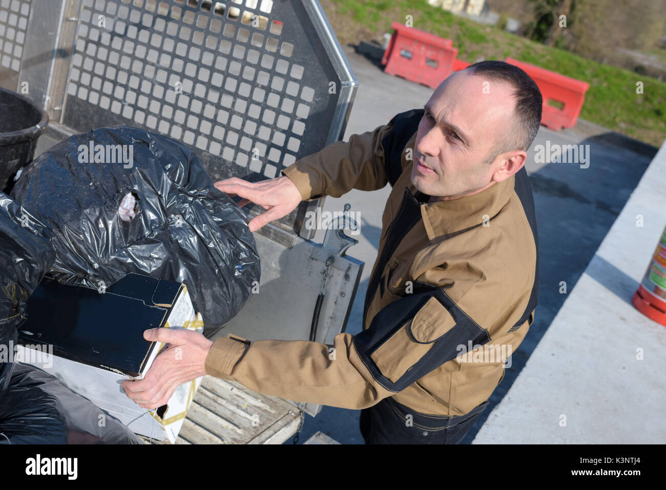 municipal dustman worker with cleaning tools in public streets Stock Photo