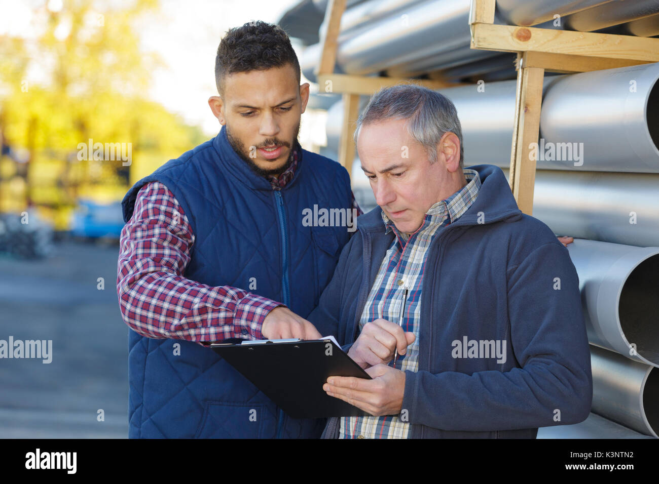 petrochemical co-workers working at refinery plant Stock Photo