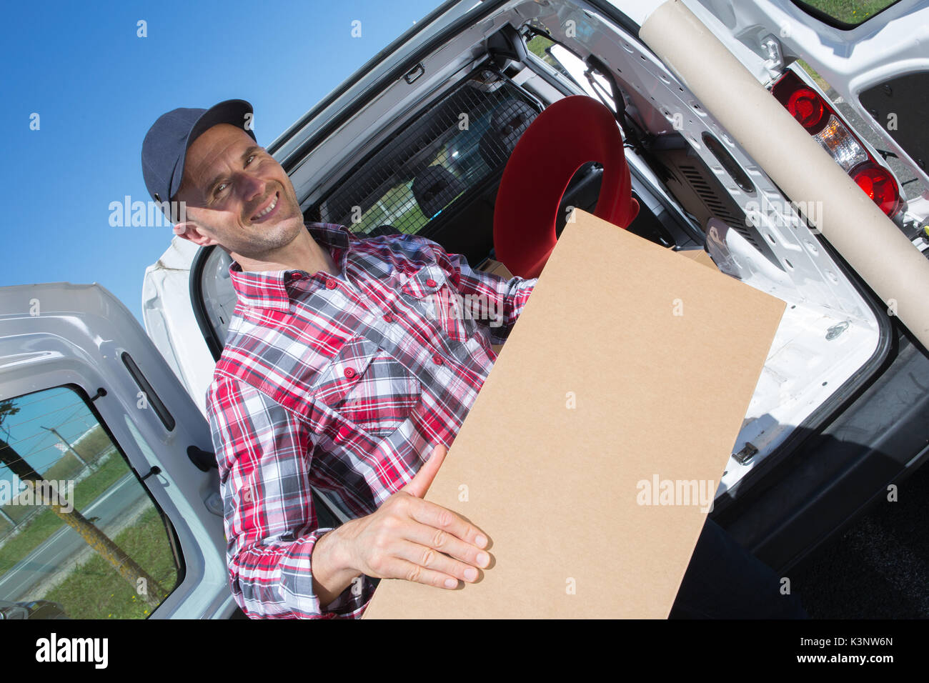 male movers unloading from truck Stock Photo