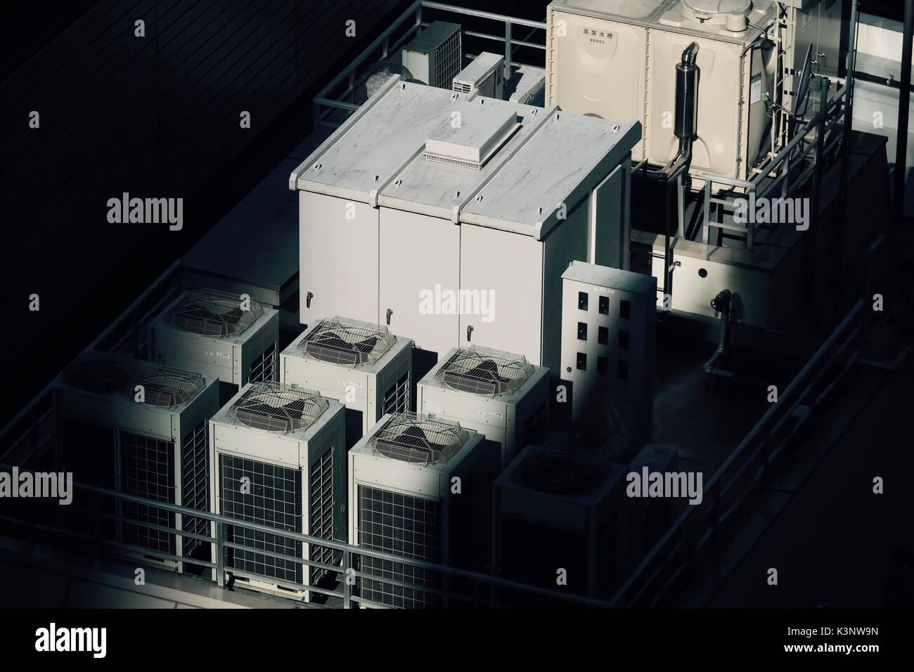 Water tank and air conditioner compressors at the rooftop of an office building in Shinjuku, Tokyo, Japan Stock Photo