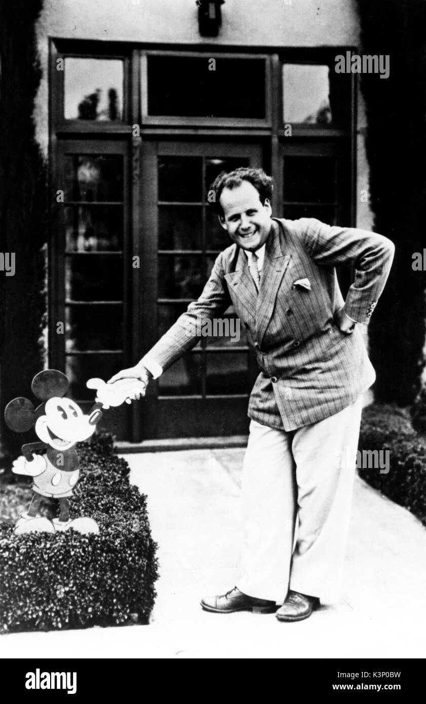 SERGEI EISENSTEIN [1898 - 1948] Russian Director, Writer and Editor Shaking hands with Mickey Mouse during his visit to the Walt Disney Studio, 1930     Date: 1948 Stock Photo