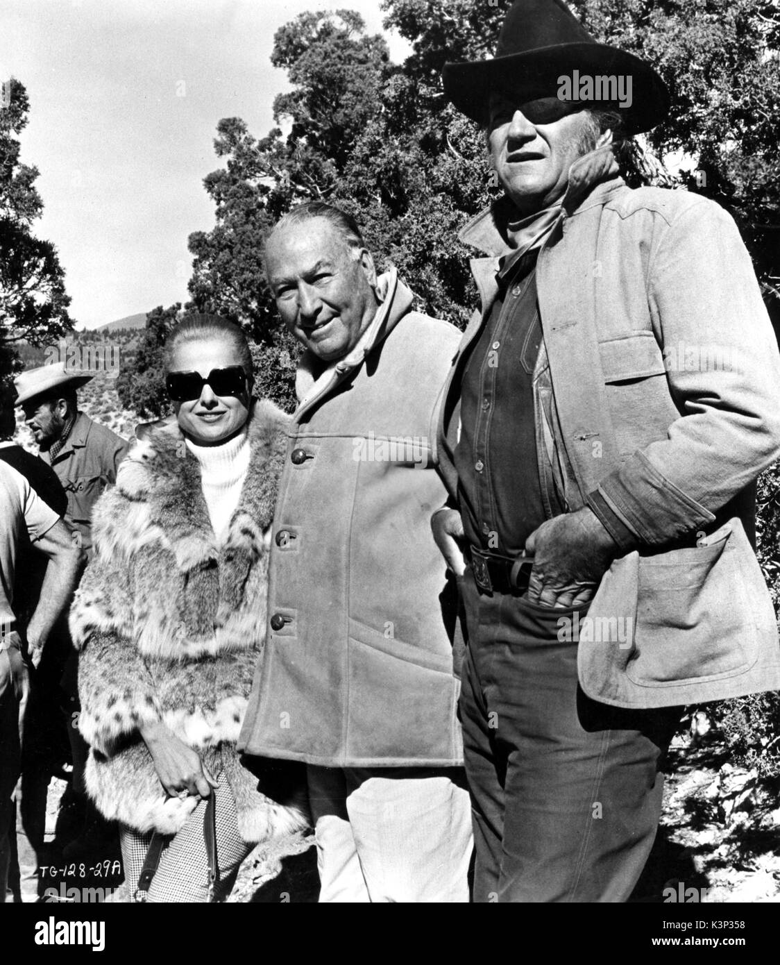 TRUE GRIT [US 1969] HAL B WALLIS [centre] with his wife MARTHA HYER and JOHN WAYNE on location     Date: 1969 Stock Photo