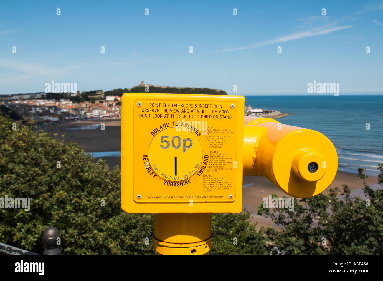 A yellow seaside telescope overlooking Scarborough South Bay in North Yorkshire, England. SCARBOROUGH, NORTH YORKSHIRE, UK - AUG 10, 2017 Stock Photo