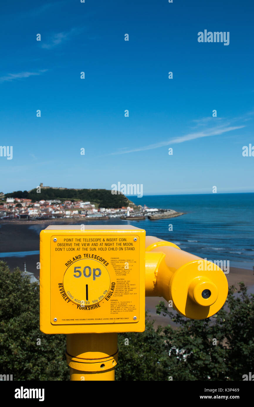 A yellow seaside telescope overlooking Scarborough South Bay in North Yorkshire, England. SCARBOROUGH, NORTH YORKSHIRE, UK - AUG 10, 2017 Stock Photo