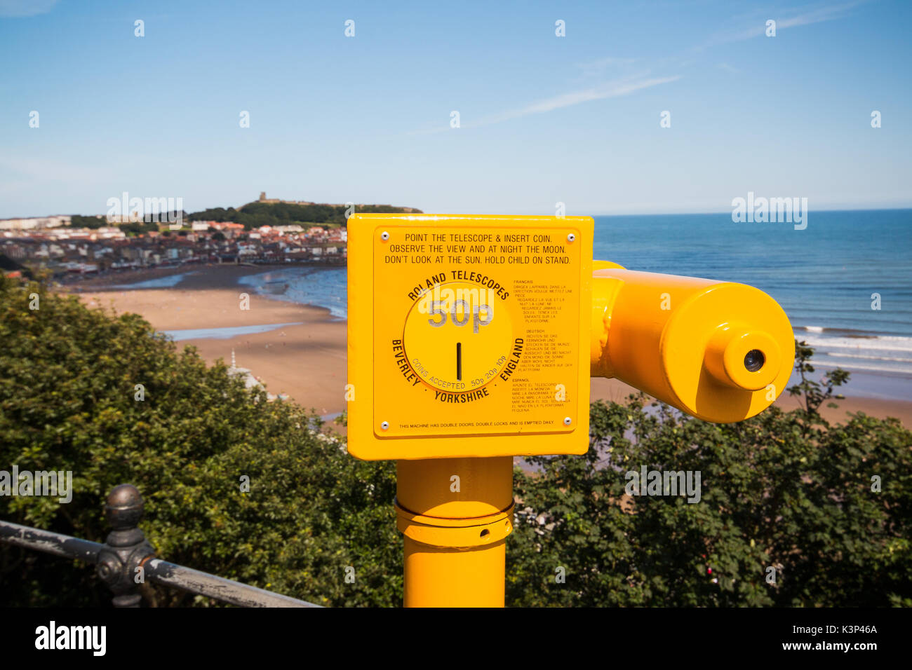 A yellow seaside telescope overlooking Scarborough South Bay in North Yorkshire, England. SCARBOROUGH, NORTH YORKSHIRE, UK - AUG 10, 2017 Stock Photo