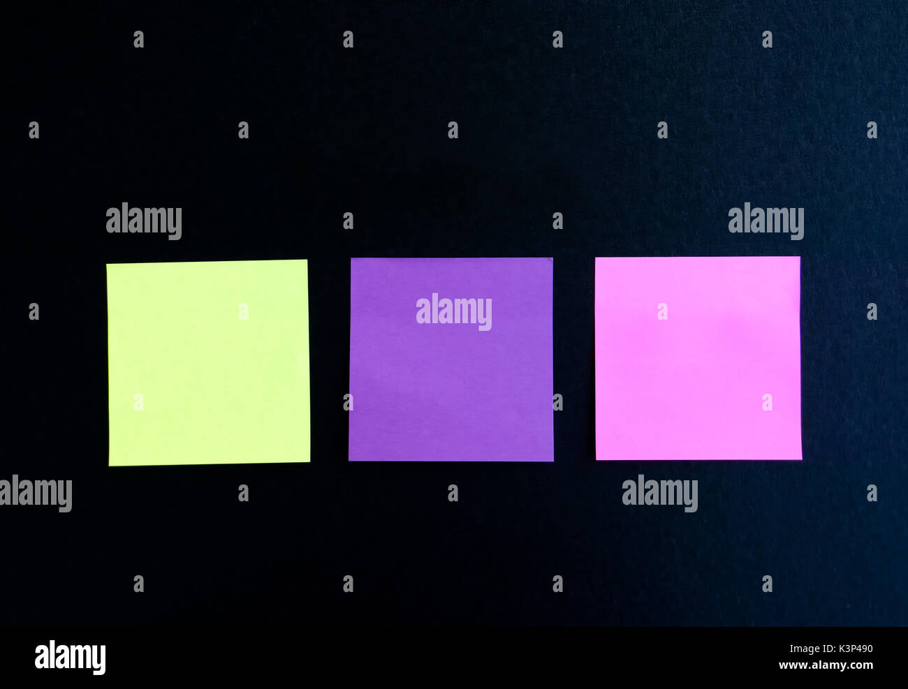 Three multi colored blank sticky note on black background Stock Photo ...