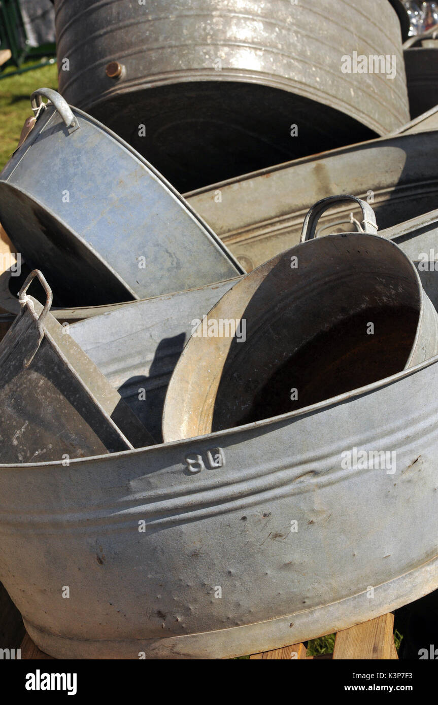 A collection assortment of galvanised steel basins buckets and bathtubs
