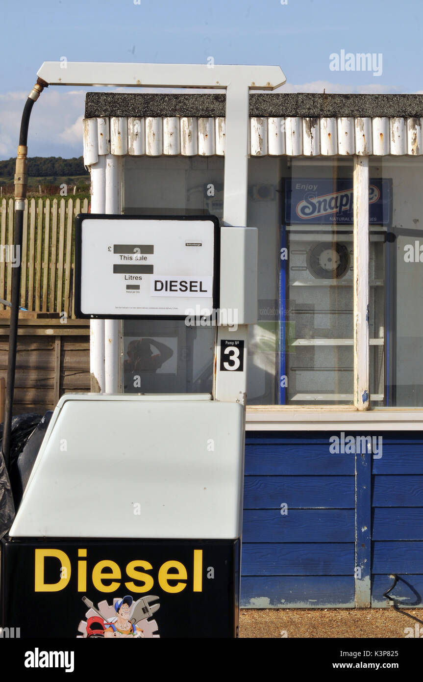 redundant petrol pumps disused at a derelict garage no longer selling petrol or diesel fuels of the future gasoline derv out of use rusty fuel petrol Stock Photo