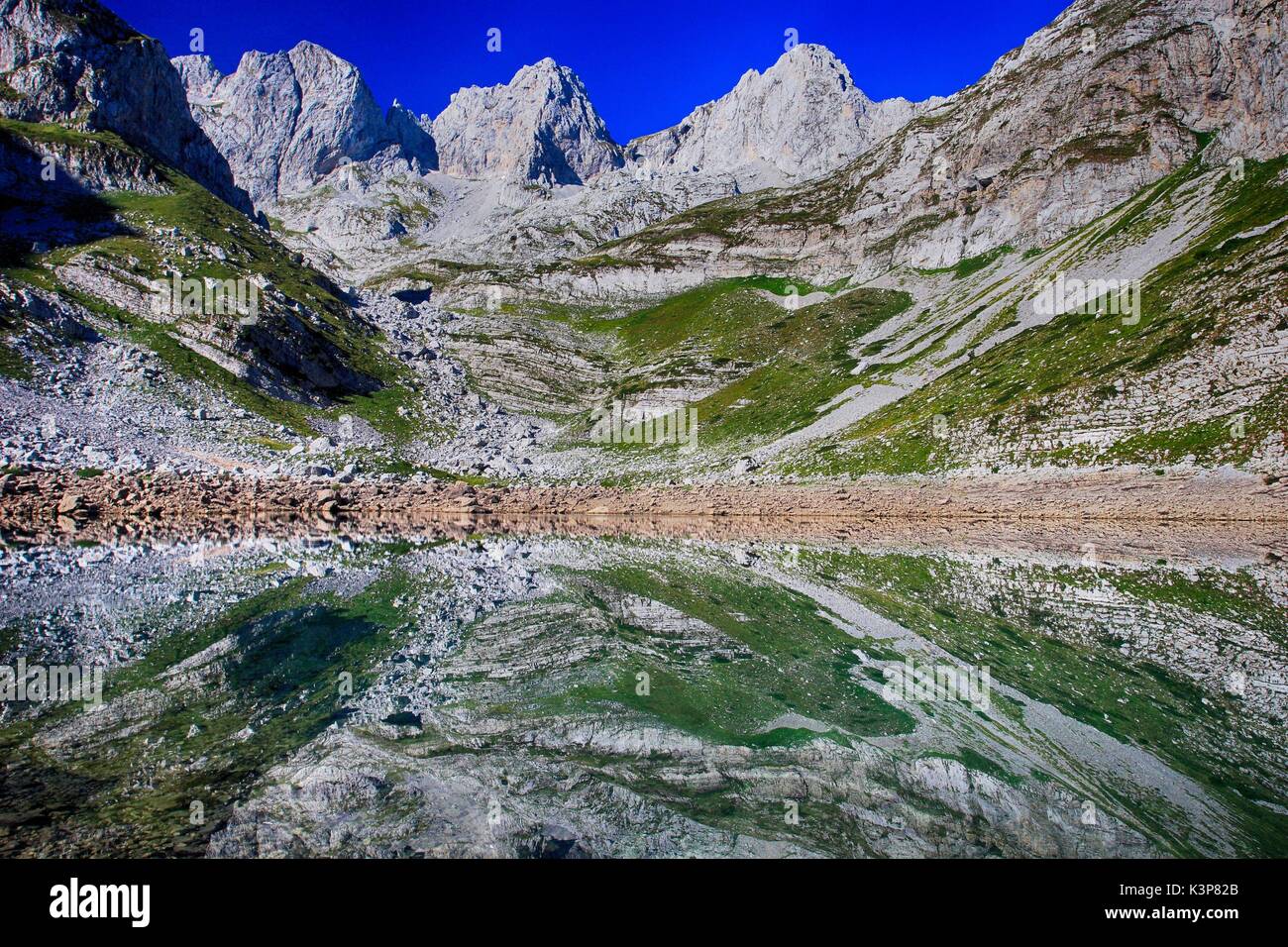 Reflections in a glacial lake in the 7 lakes valley (Buni Jezerces) in Prokletije / Bjeshket e Namuna / Accursed Mountains Mountains Stock Photo