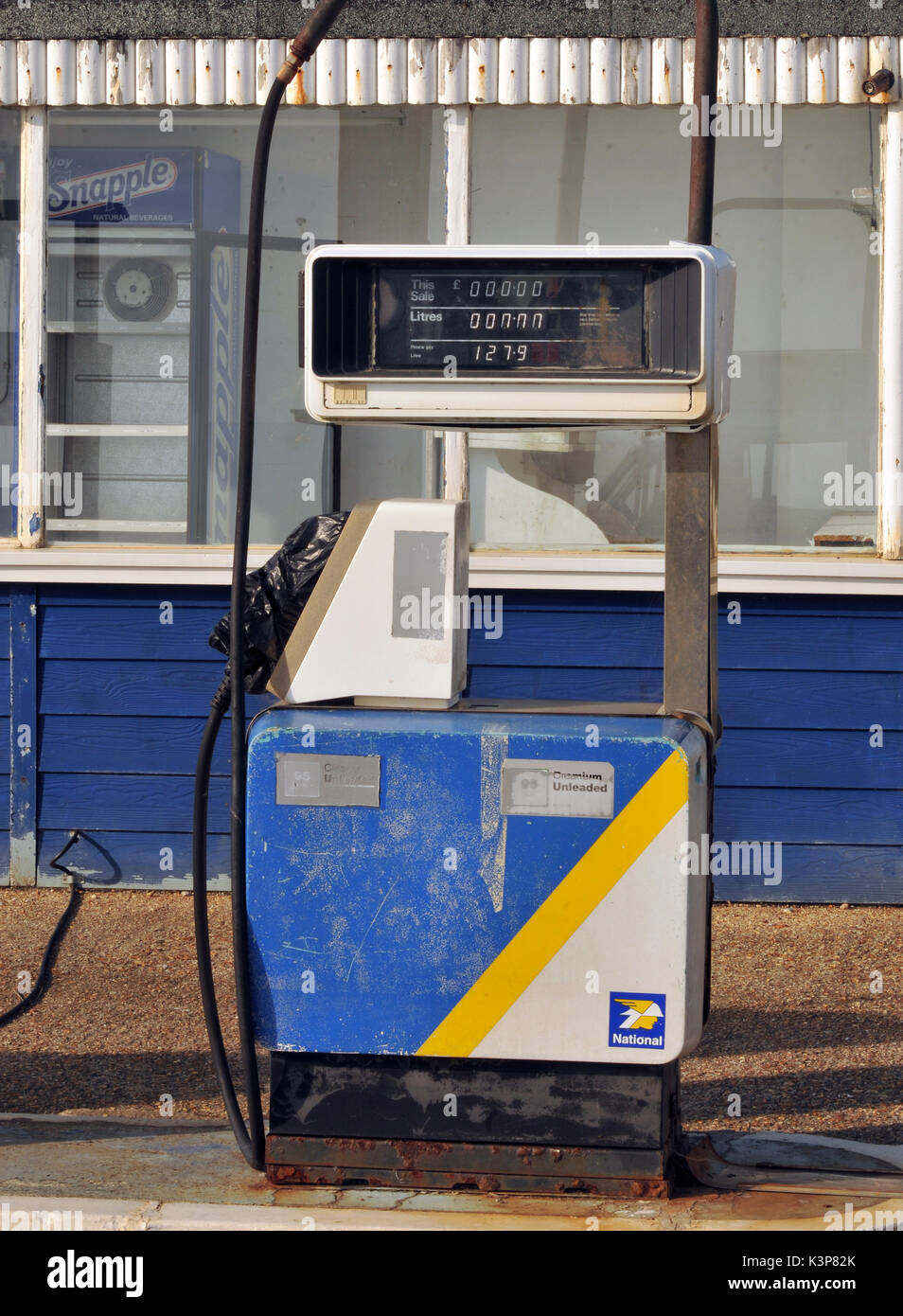 redundant petrol pumps disused at a derelict garage no longer selling petrol or diesel fuels of the future gasoline derv out of use rusty fuel petrol Stock Photo