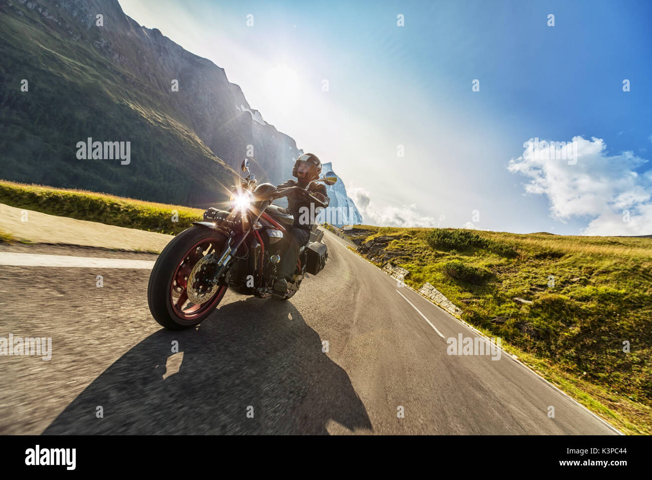 Motorcycle driver riding in Alpine highway, Hochalpenstrasse, Austria ...