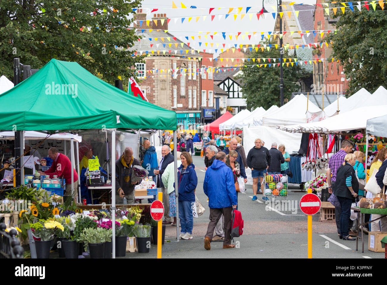 People visiting the popular market day in the high street at the North Wales market town of Mold, Flintshire, Wales, UK Stock Photo