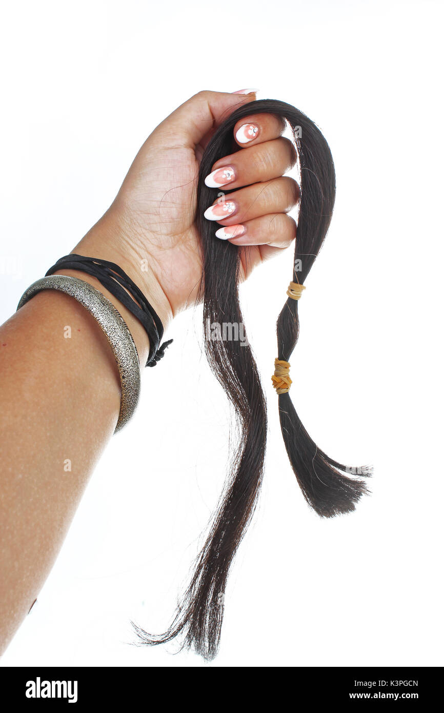Woman hand holding hair extension human hair on isolated white cutout background. Studio photo with studio lighting easy to use for every concept. Stock Photo
