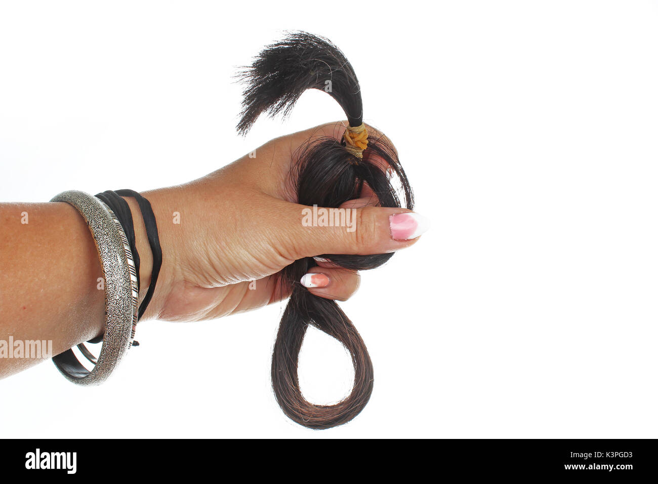 Woman hand holding hair extension human hair on isolated white cutout background. Studio photo with studio lighting easy to use for every concept. Stock Photo