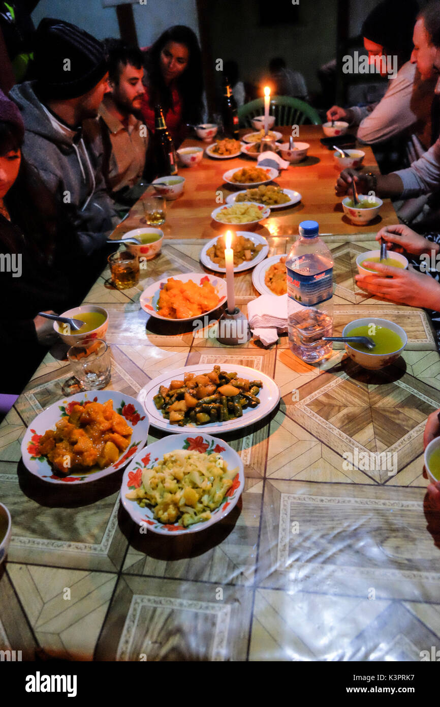 Hungry hikers eat dinner after a day trekking on the Kalaw to Inle Lake track Stock Photo
