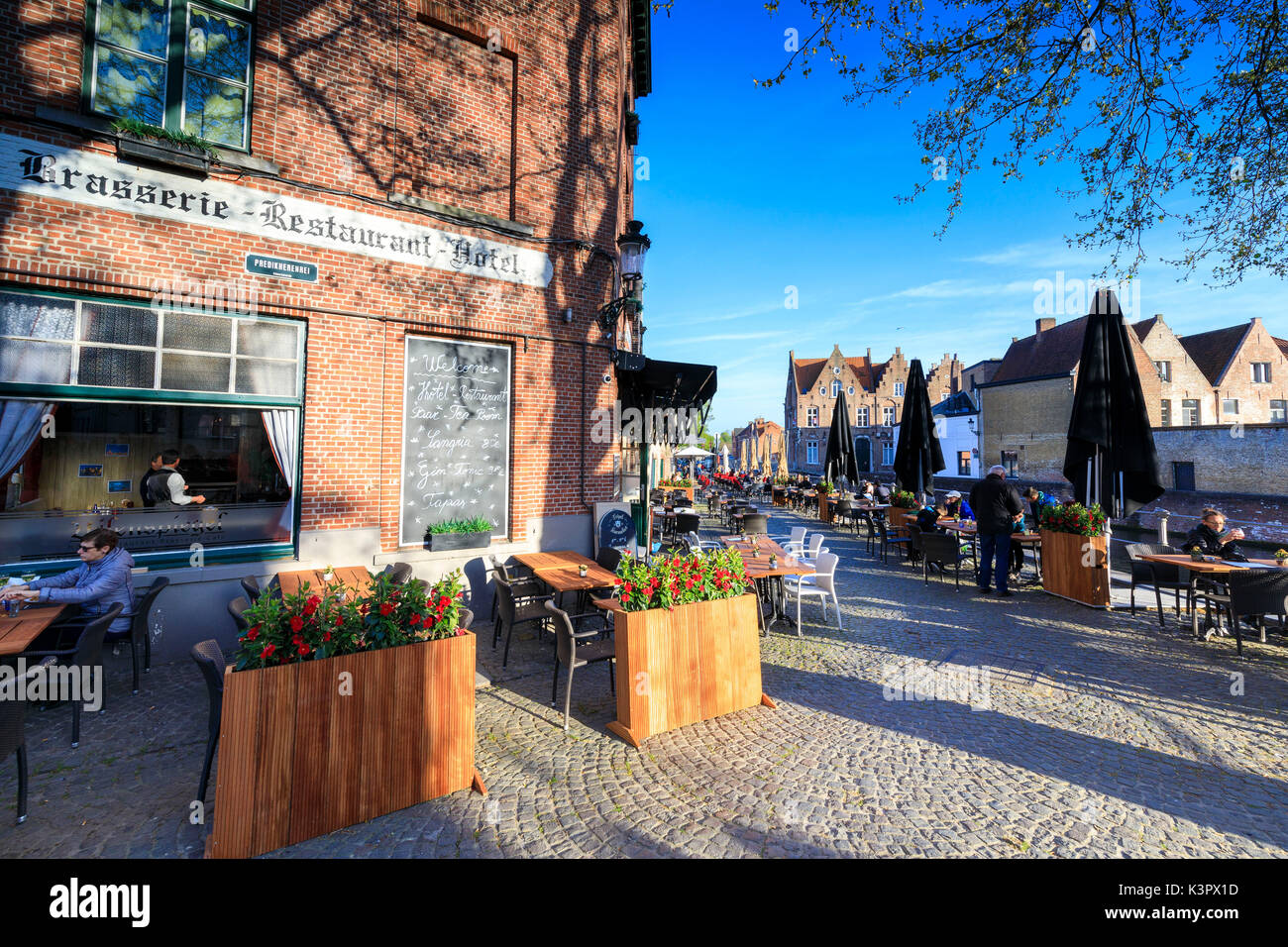 Typical brasserie and cafe shops along the old town on the canal Bruges West Flanders Belgium Europe Stock Photo