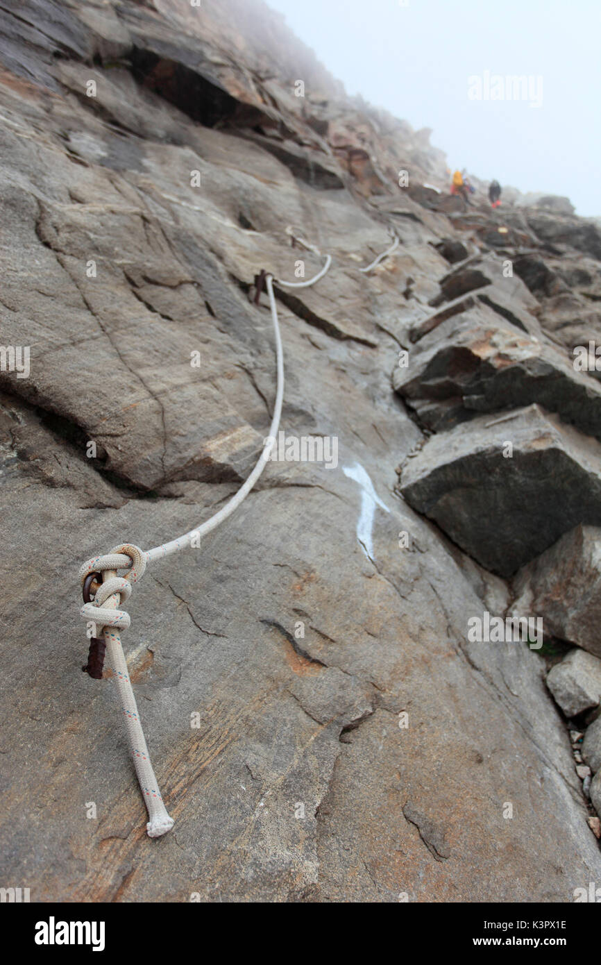 The typical rope 'Canapone' with alpinist are aided to overpass some difficulties, towards Capanna Gnifetti, Monte Rosa, Verbano Cusio-Ossola, Piemonte ,Italy Stock Photo