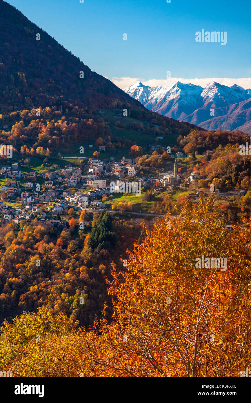 The bright colors of the  autumn painting the landscape surrounding the small village of Sacco Orobie Alps, Valtellina, Sondrio, Lombardy, Italy Europe Stock Photo