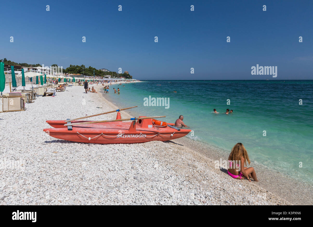 Tourists on the beach framed by the turquoise sea province of Ancona Conero Riviera Marche Italy Europe Stock Photo