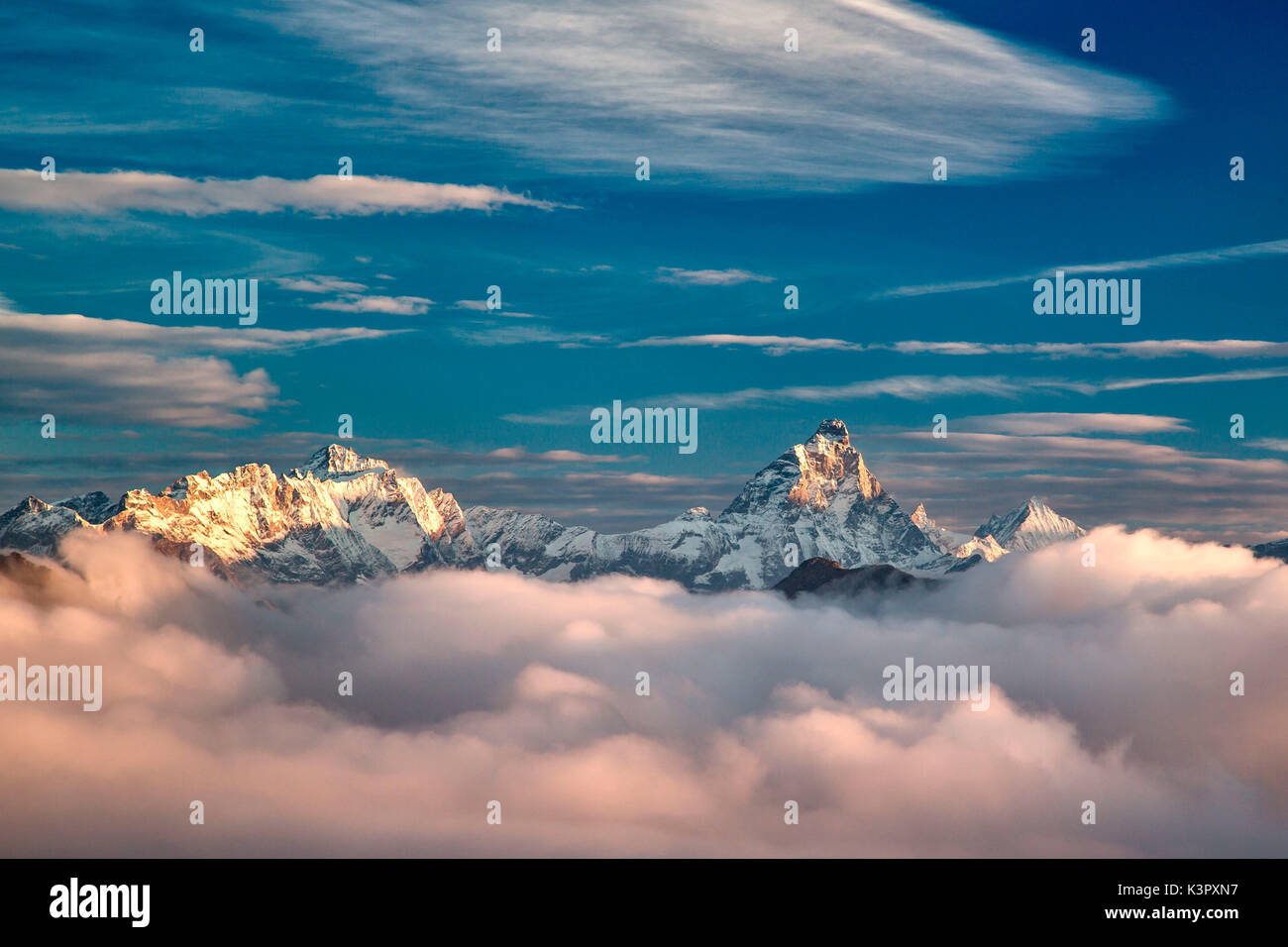 The morning fog of an autumn morning trying to conceal the majesty of the Matterhorn, Dent d'Herens and Weisshorn  - Alps, Aosta valley, Italy Europe Stock Photo