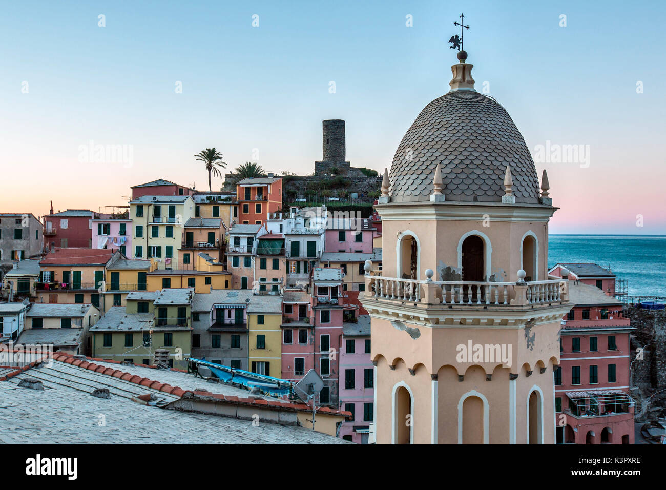 A detail of the church of Vernazza, one of the prettiest village of the Cinque Terre. In the background, pastel-colored houses overlooking the little natural harbor make Vernazza simply enchanting - Cinque Terre National ParK, Liguria, Italy Europe Stock Photo