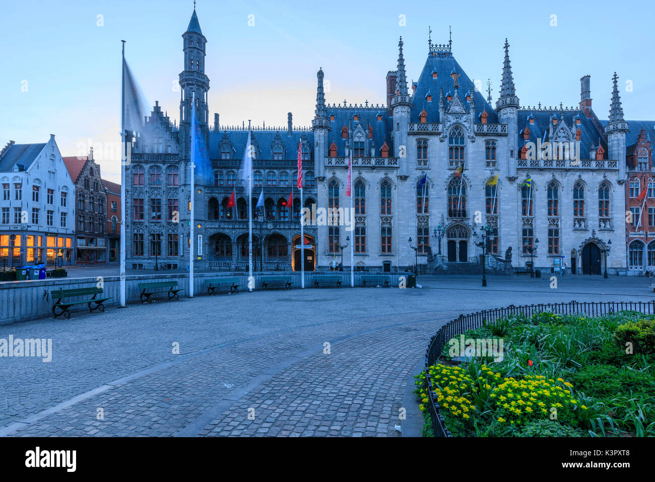 Blue lights of dusk on the gothic palace of the Provinciaal Hof in Market Square Bruges West Flanders Belgium Europe Stock Photo