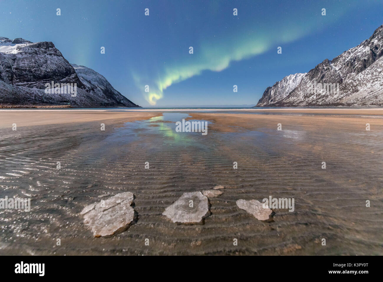 Sandy beach and snowy peaks framed by the Northern Lights in the polar night Ersfjord Senja Tromsø Norway Europe Stock Photo