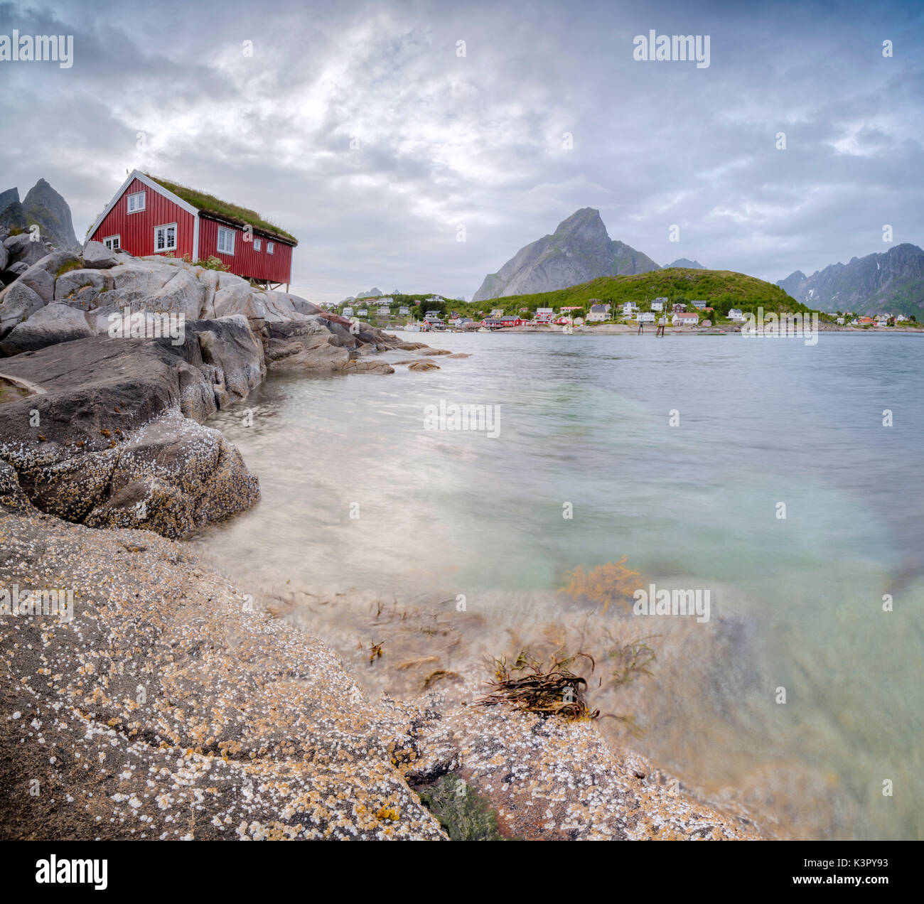 Panoramic of the typical Rorbu surrounded by peaks and clear sea Reine Nordland county Lofoten Islands Northern Norway Europe Stock Photo