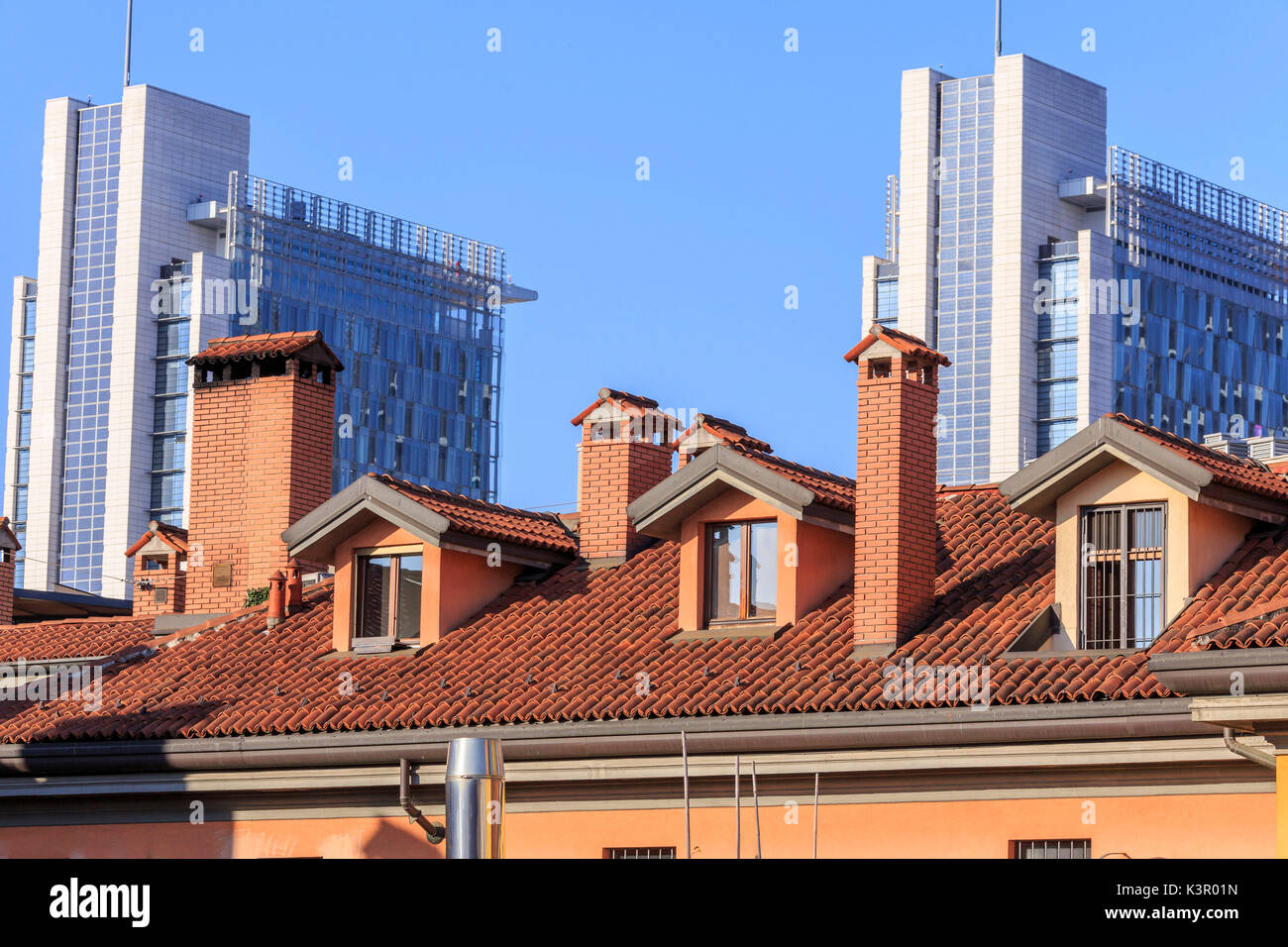 The contrast between old typical houses and new modern buildings and skyscrapers Milan Lombardy Italy Europe Stock Photo