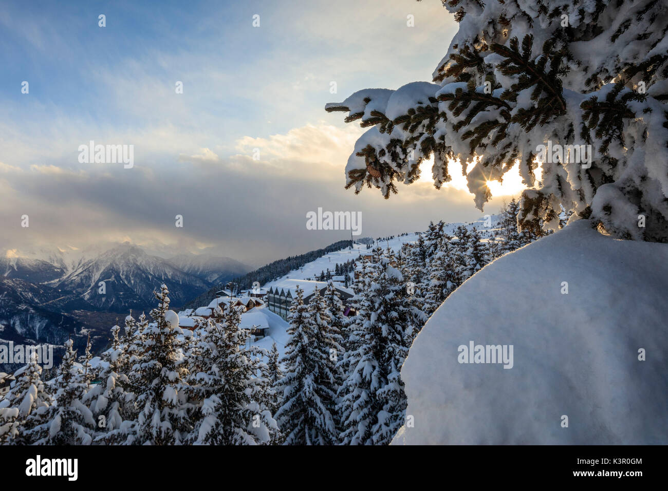 Sunbeam in the snowy woods framed by the winter sunset Bettmeralp district of Raron canton of Valais Switzerland Europe Stock Photo