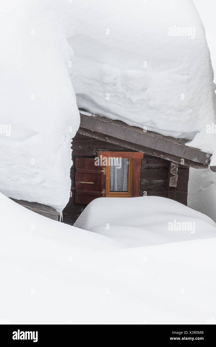 A typical wooden mountain hut submerged by snow Bettmeralp district of Raron canton of Valais Switzerland Europe Stock Photo