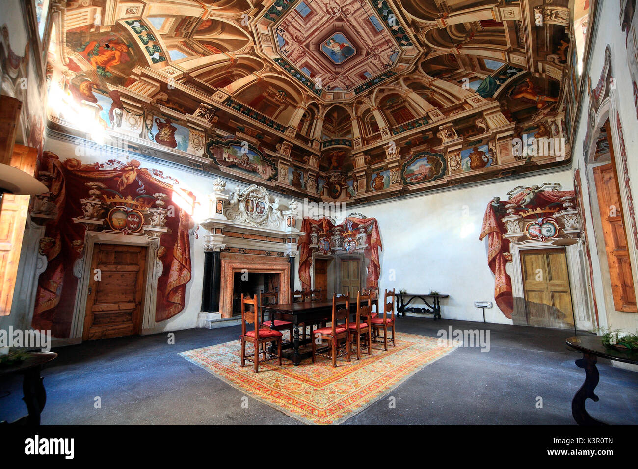 The 'Saloncello' (the Reading Hall) in the Sertoli Salis Palace, which shows one of the most relevant decorations with an interesting frescoed ceiling and a Baroque fireplace with plasterwork decorations representing the Salis and Wolkenstein coats of arms - Tirano, Valtellina, Lombardy Italy Europe Stock Photo