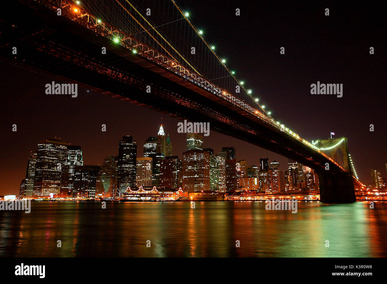 The Brooklyn Bridge at night and the skyline of New York USA Stock Photo