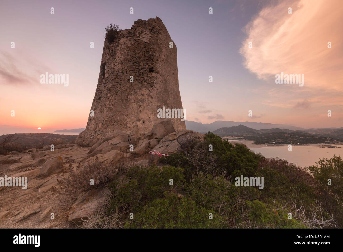Sunset on the stone tower overlooking the bay Porto Giunco Villasimius Cagliari Sardinia Italy Europe Stock Photo