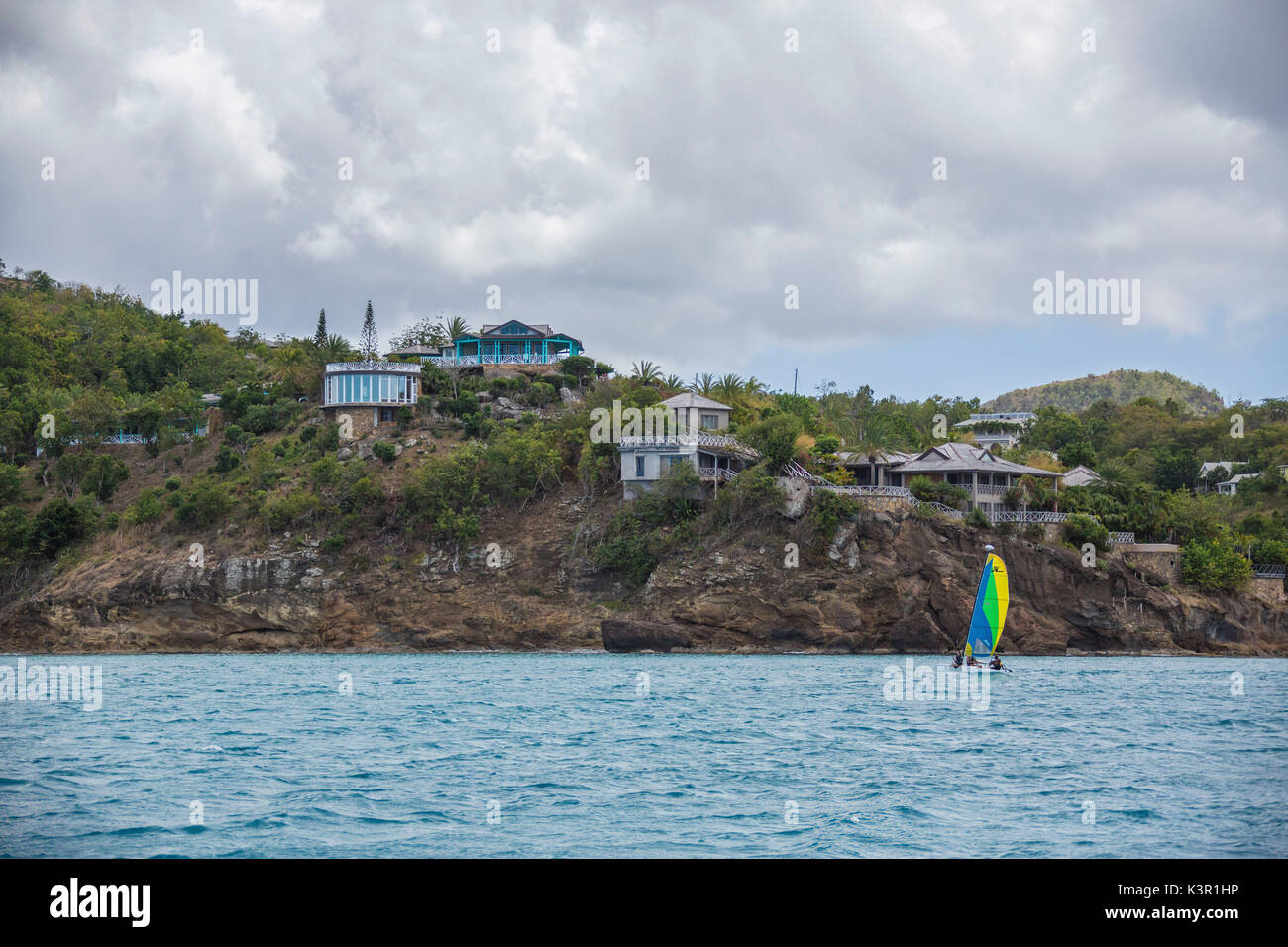 The Caribbean sea and a tourist resort seen from a boat tour in a cloudy day Antigua and Barbuda Leeward Islands West Indies Stock Photo