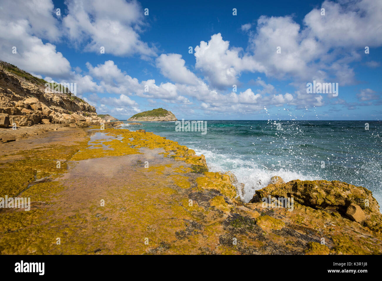 The waves of Caribbean sea crashing on the cliffs Half Moon Bay Antigua and Barbuda Leeward Island West Indies Stock Photo