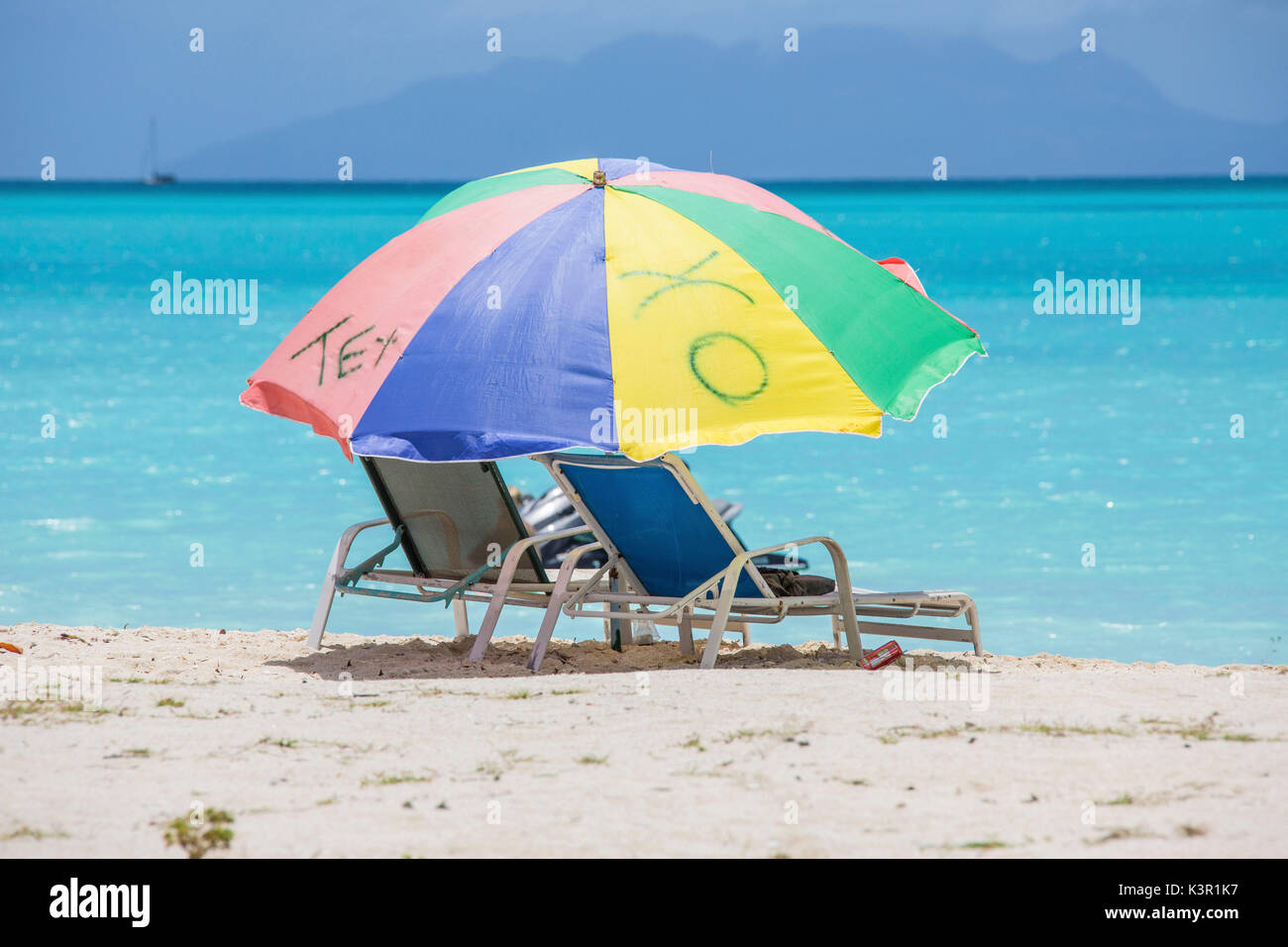Sunbeds and beach umbrellas at Jolly Beach Caribbean Antigua and Barbuda Leeward Island West Indies Stock Photo