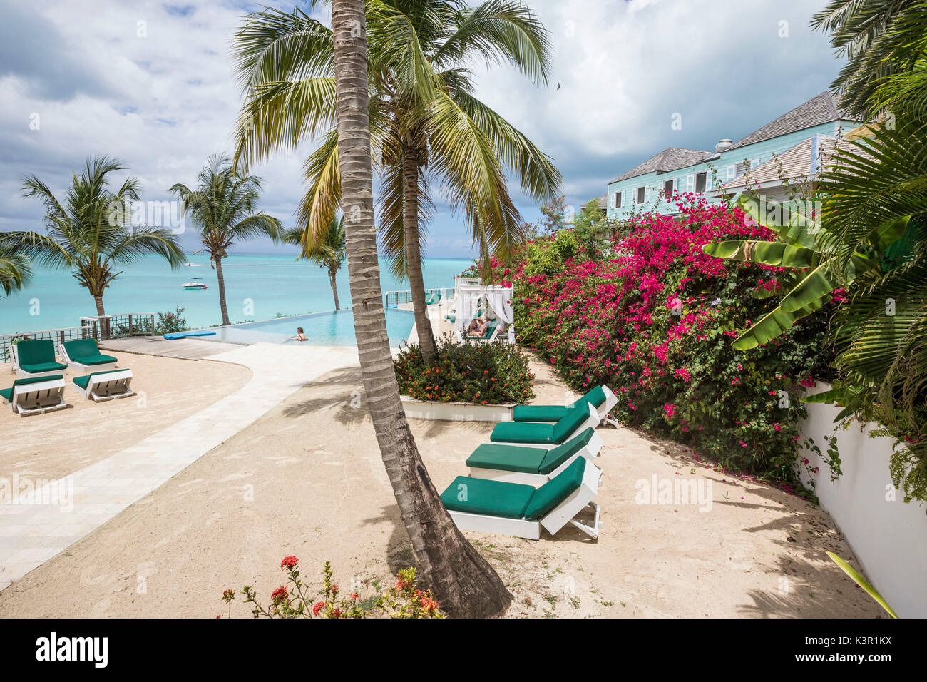 Sunbeds and palm trees overlooking the Caribbean Sea Ffryes Beach Sheer Rocks Antigua and Barbuda Leeward Island West Indies Stock Photo