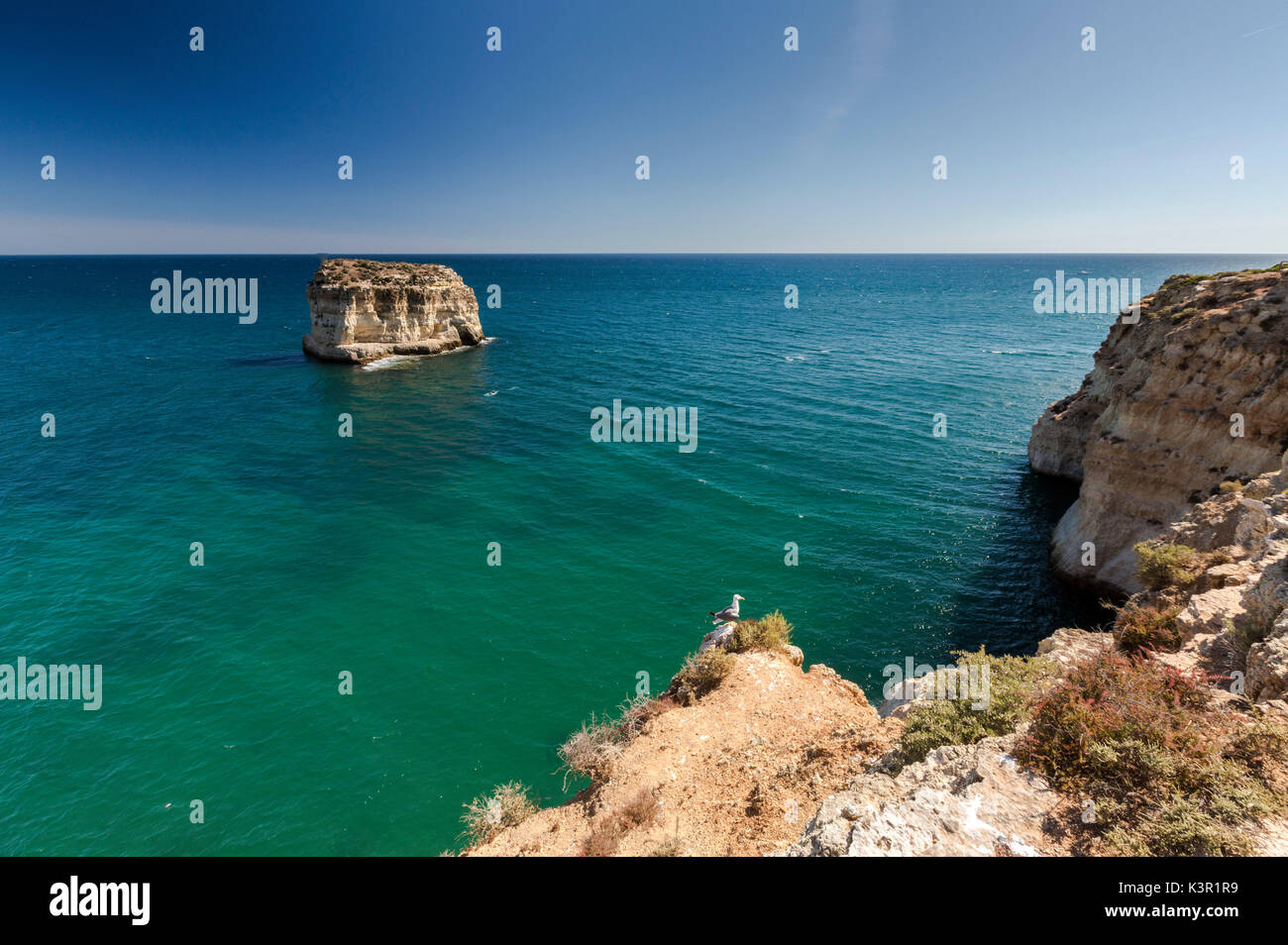 The turquoise water of the Atlantic Ocean frames the cliffs of Praia do Torrado  Algarve Lagoa Faro District Portugal Europe Stock Photo
