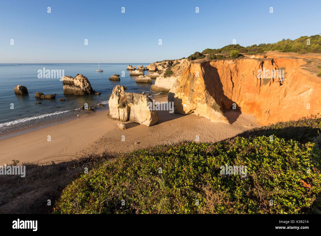 Top view of the sandy beach bathed by the blue ocean at dawn Praia do Alemao Portimao Faro district Algarve Portugal Europe Stock Photo